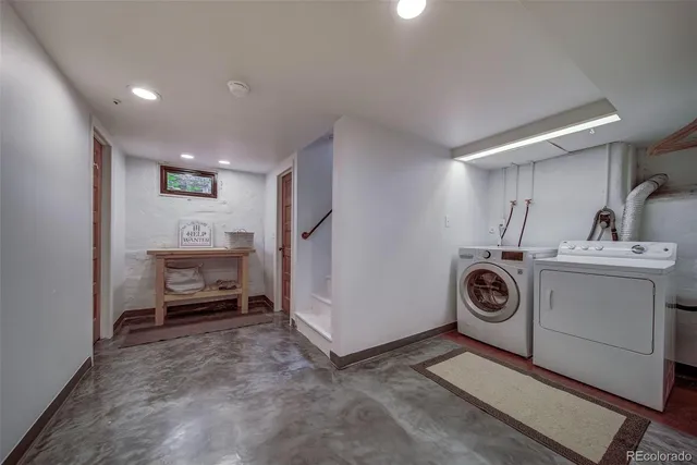 a utility room with sink dryer and washer