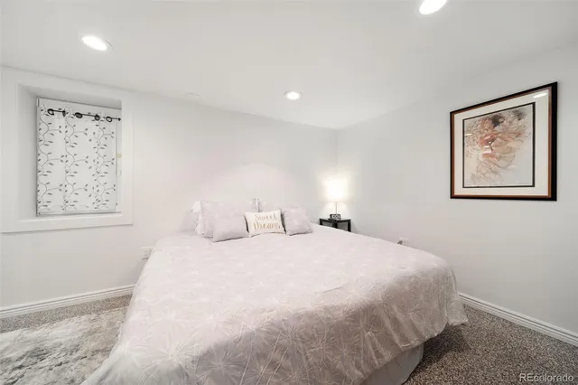 a bedroom with a large bed and a window