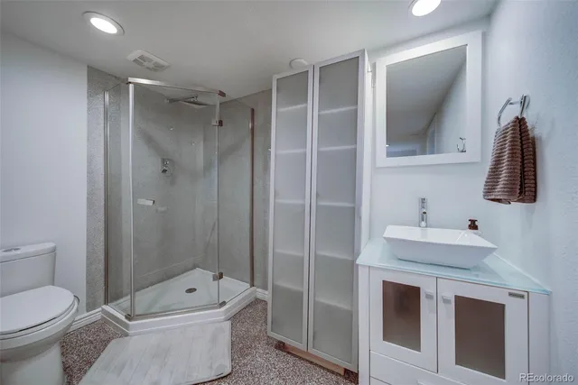 a bathroom with a sink toilet and shower