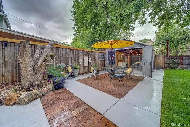a view of a backyard with a patio and fire pit