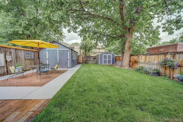 a view of a house with backyard and sitting area
