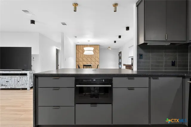 a kitchen with a sink and cabinets