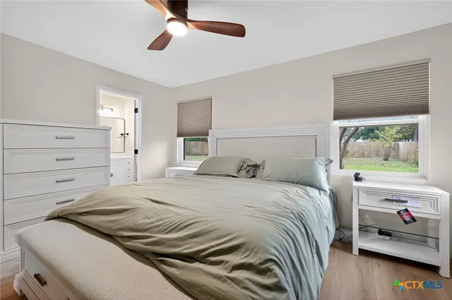 a bedroom with a bed and a window