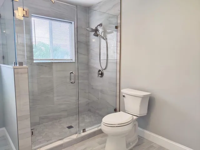 a bathroom with a toilet and shower