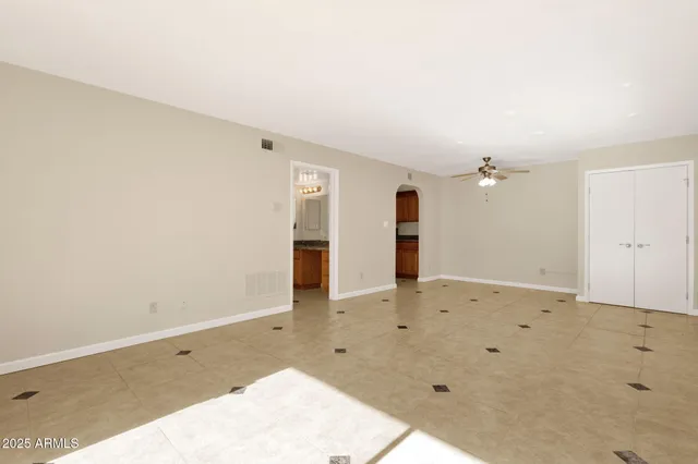 an empty room with closet and a window