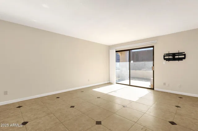 an empty room with a ceiling fan