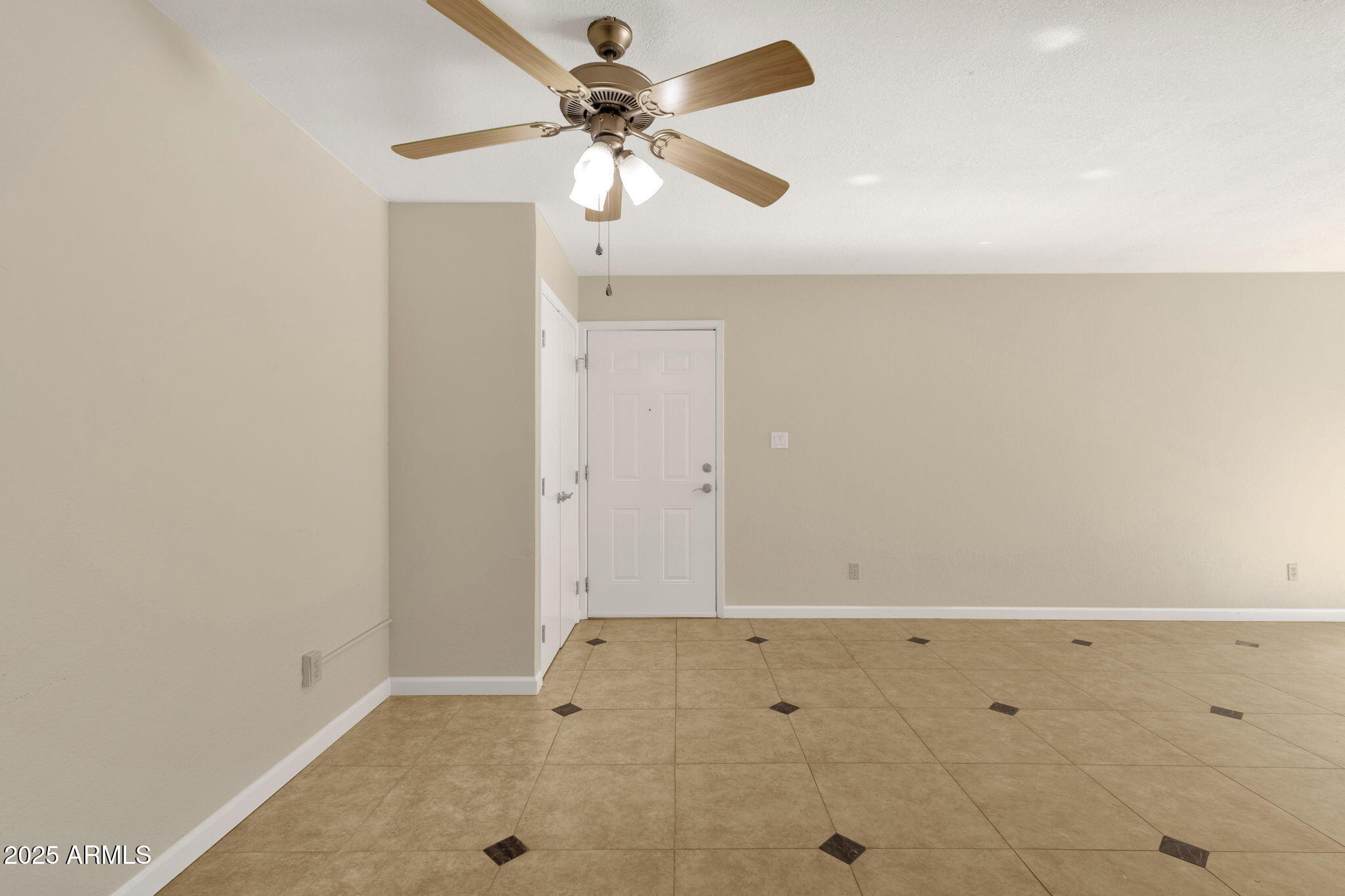 3825 East Camelback Road, Unit 120 Phoenix, AZ 85018 - Photo 16 of 39 an empty room with a ceiling fan
