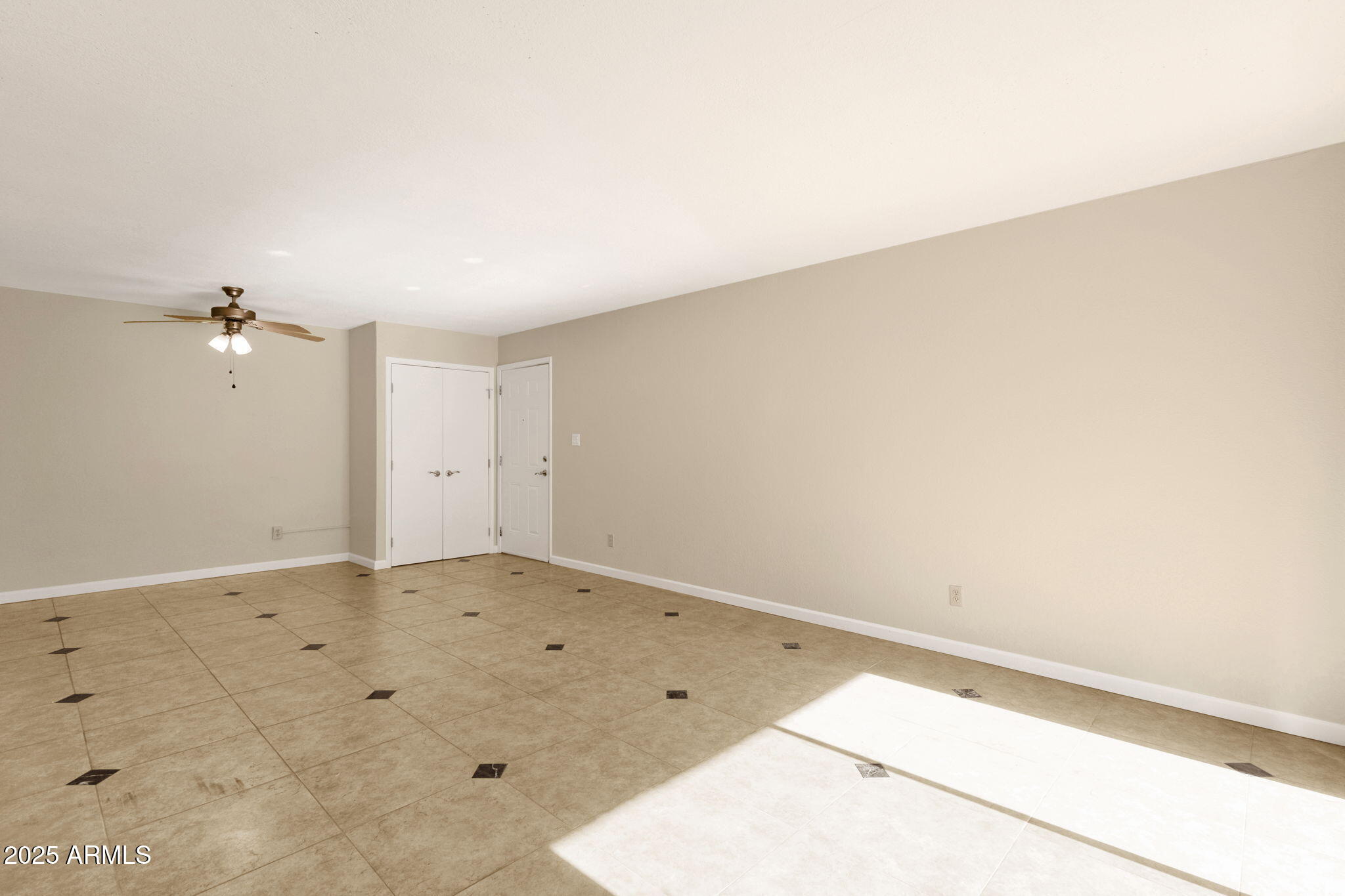 3825 East Camelback Road, Unit 120 Phoenix, AZ 85018 - Photo 18 of 39 an empty room with a chandelier fan