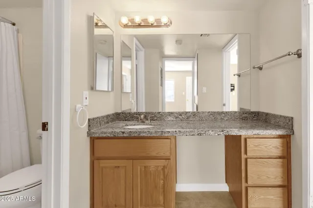 an empty room with a window and ceiling fan