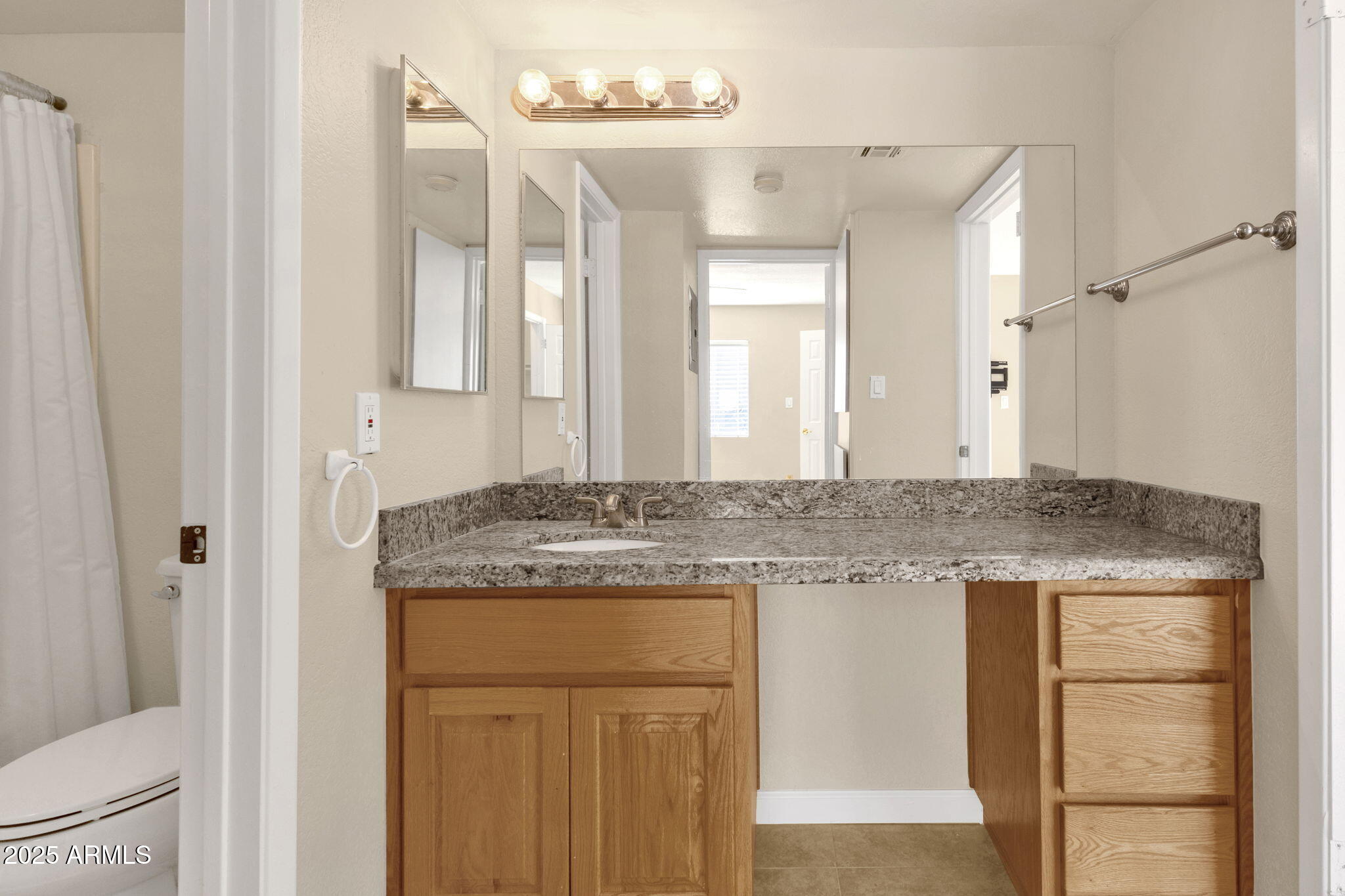 3825 East Camelback Road, Unit 120 Phoenix, AZ 85018 - Photo 20 of 39 a bathroom with a granite countertop sink and a mirror