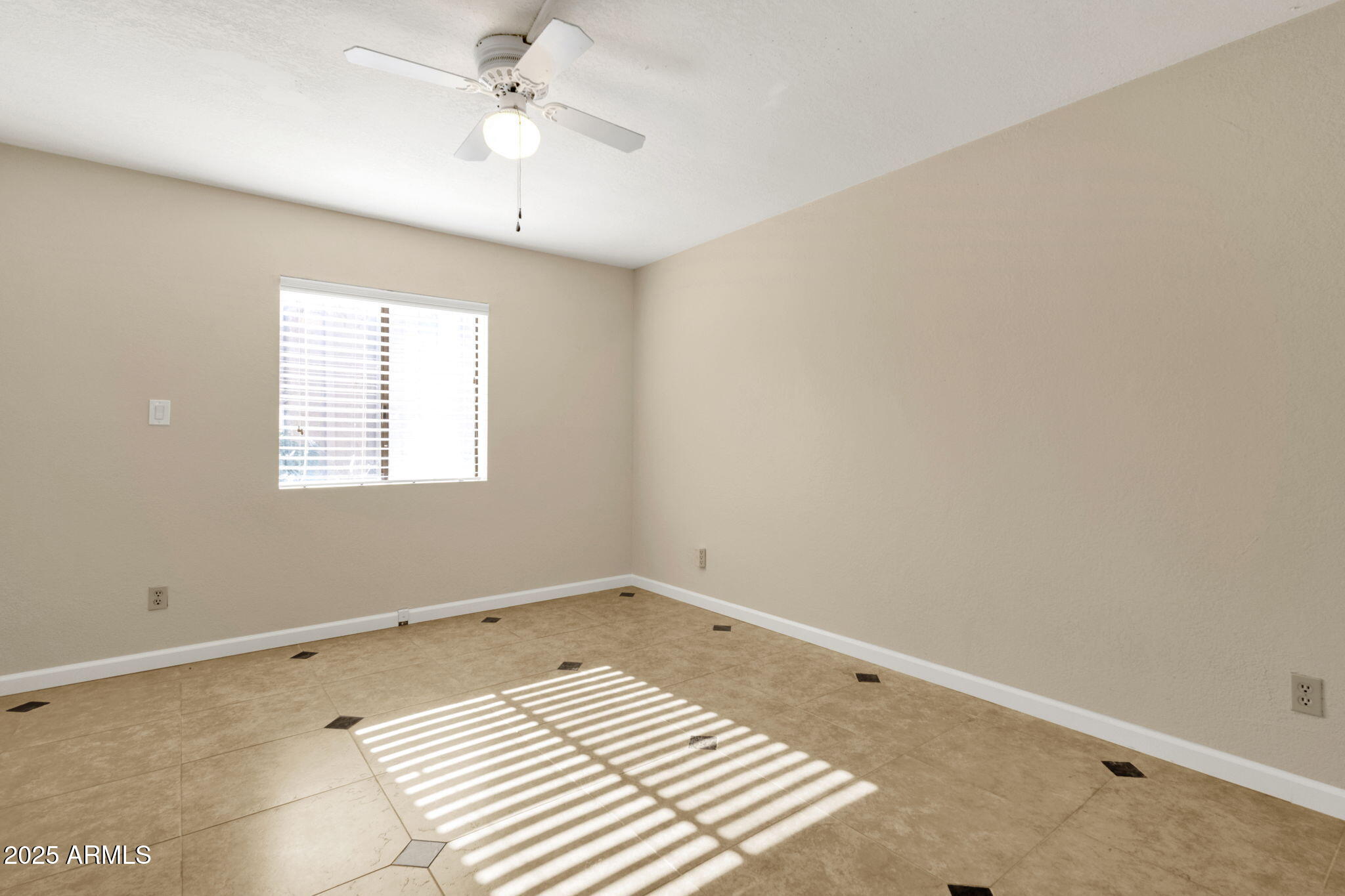 3825 East Camelback Road, Unit 120 Phoenix, AZ 85018 - Photo 24 of 39 an empty room with a window and ceiling fan