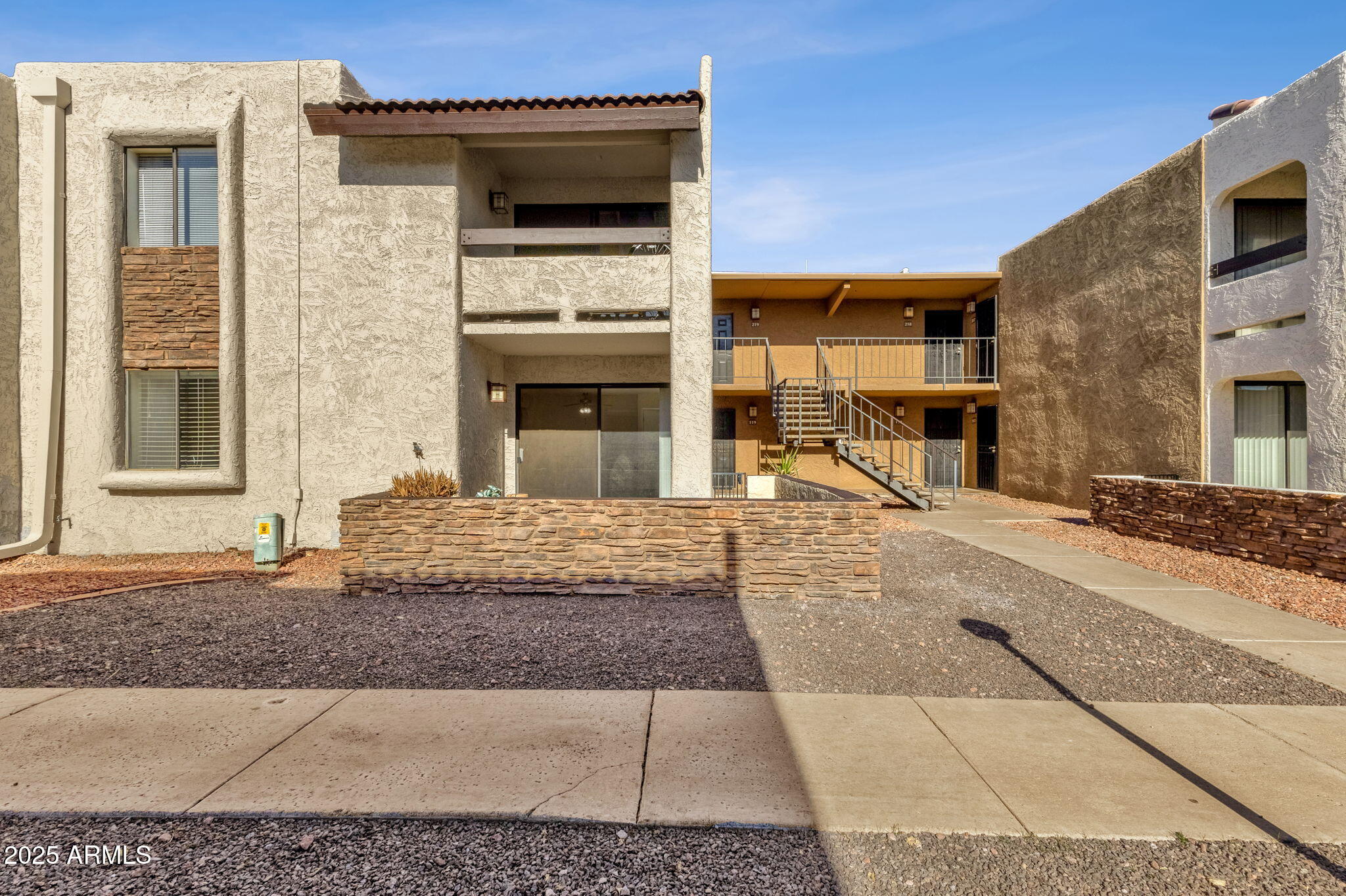 3825 East Camelback Road, Unit 120 Phoenix, AZ 85018 - Photo 26 of 39 a view of a hall with a fireplace