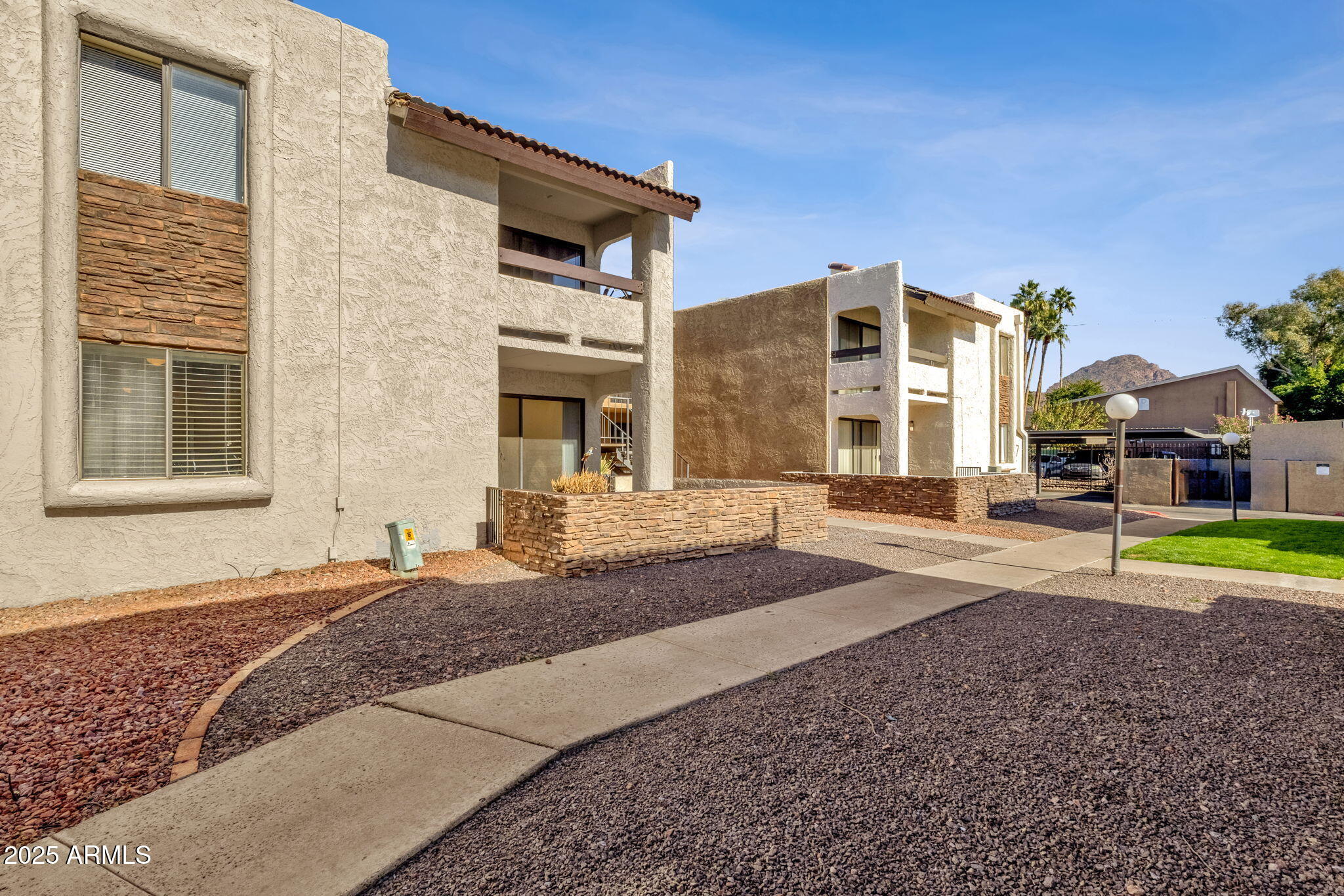 3825 East Camelback Road, Unit 120 Phoenix, AZ 85018 - Photo 27 of 39 a front view of a house with a yard