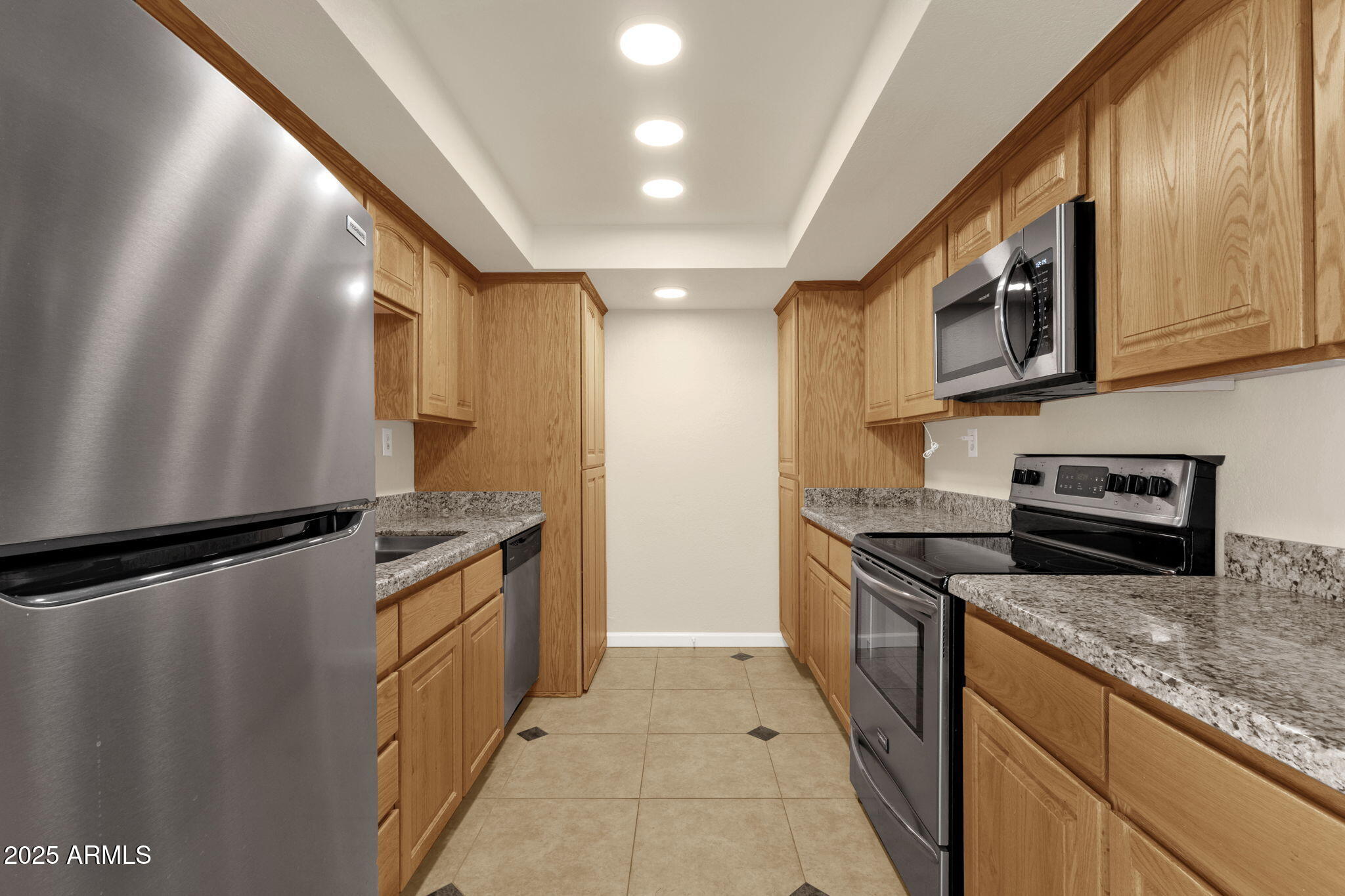 3825 East Camelback Road, Unit 120 Phoenix, AZ 85018 - Photo 5 of 39 a kitchen with stainless steel appliances granite countertop a refrigerator a stove and a sink