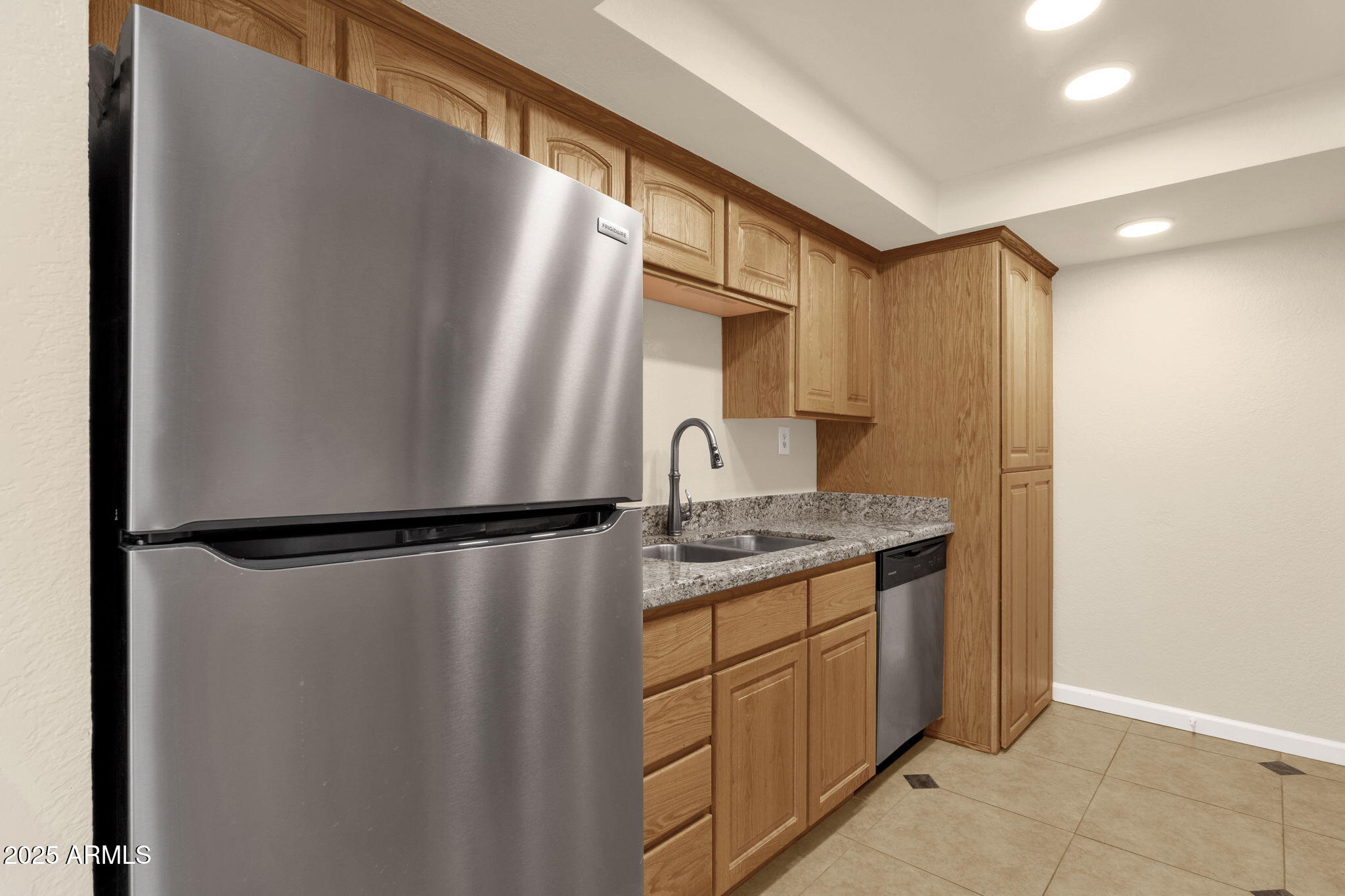 3825 East Camelback Road, Unit 120 Phoenix, AZ 85018 - Photo 7 of 39 a kitchen with a refrigerator and a sink