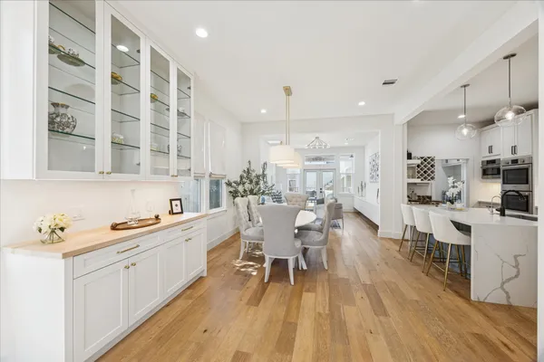 a kitchen with a sink and wooden floor