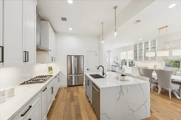 a kitchen with counter top space a sink appliances and cabinets