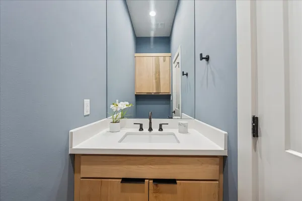 a bathroom with a sink and a mirror