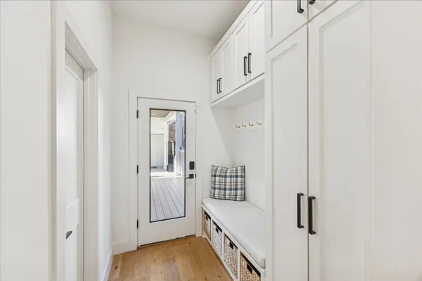 a view of a hallway with closet and wooden floor