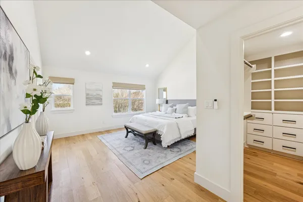 a spacious bedroom with a bed and a window