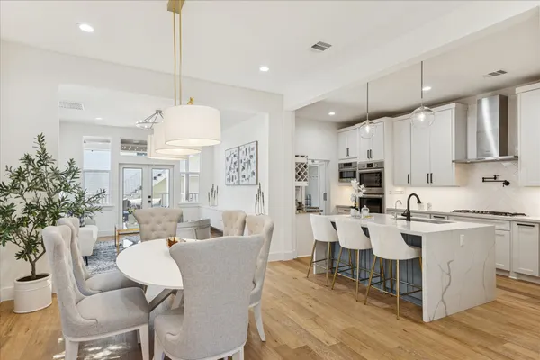 a large kitchen with cabinets table and chairs