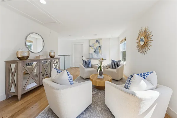 a living room with furniture a couch and a potted plant