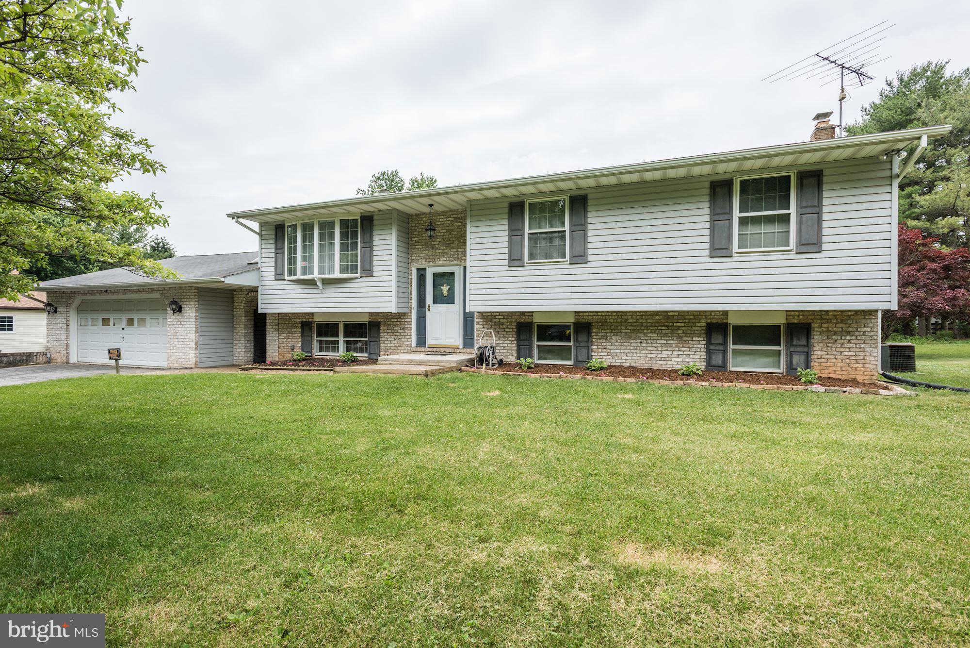 2514 Braddock Road Mount Airy, MD 21771 - Photo 1 of 30 a front view of a house with a garden