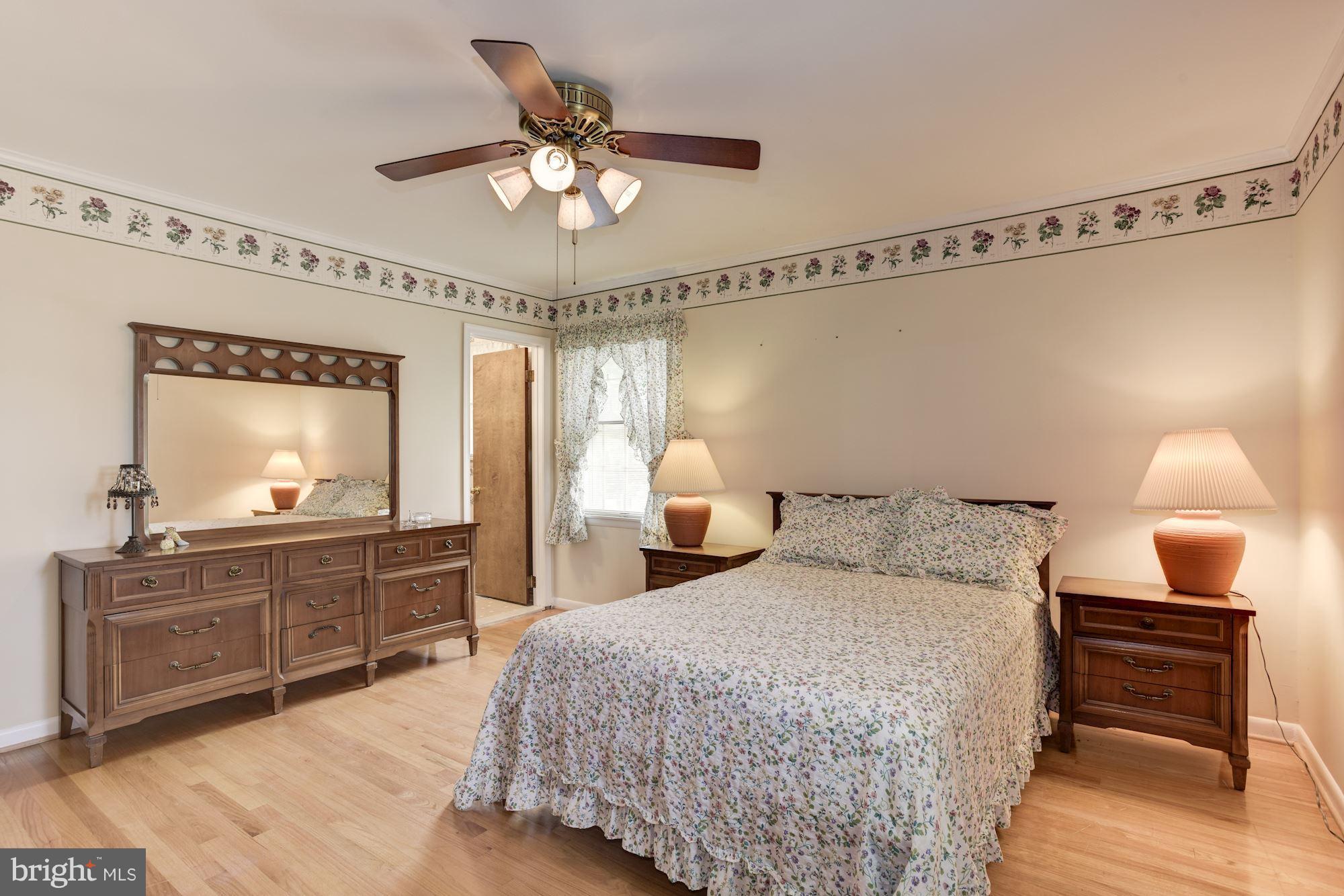 2514 Braddock Road Mount Airy, MD 21771 - Photo 11 of 30 a bedroom with a bed and a chandelier