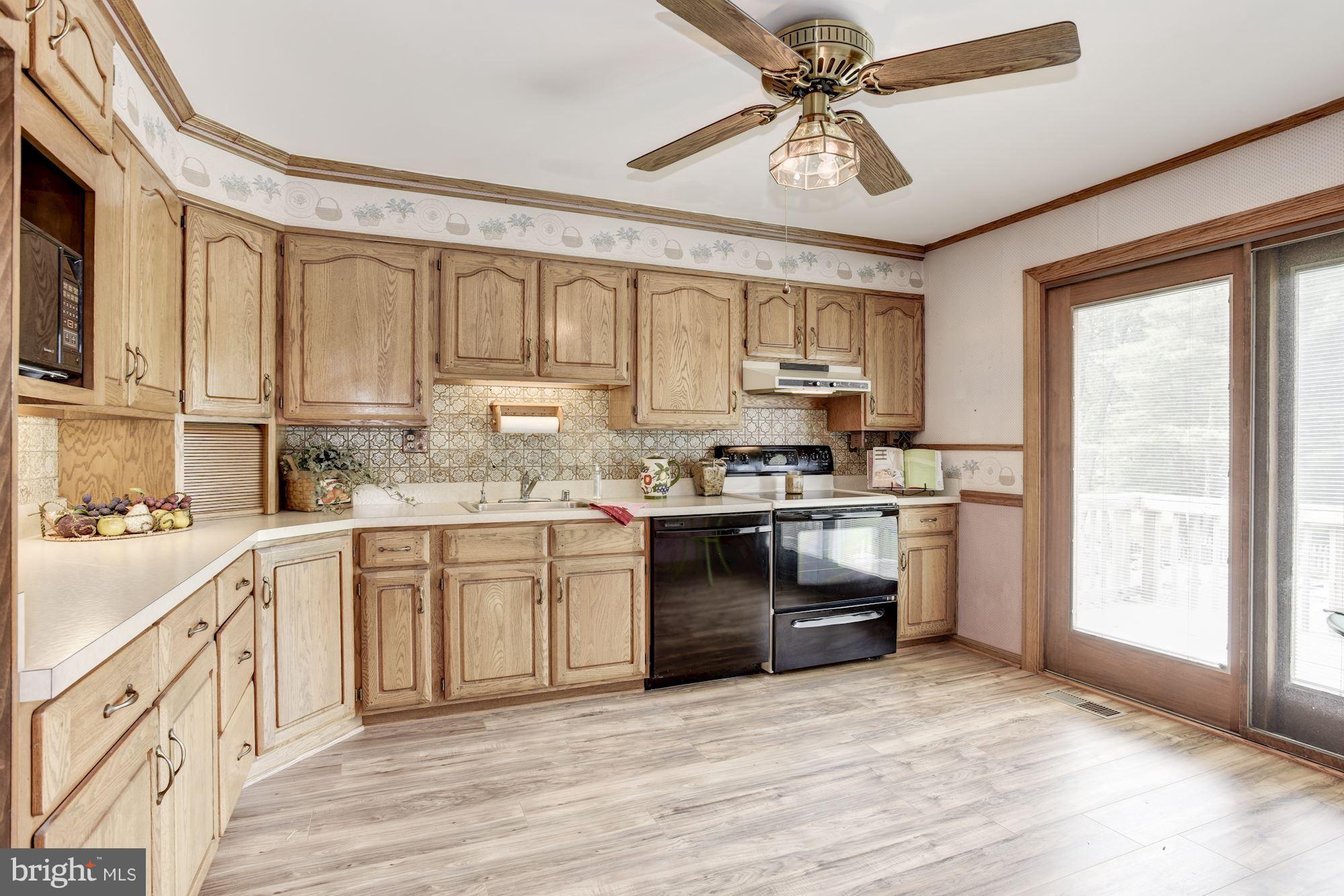 2514 Braddock Road Mount Airy, MD 21771 - Photo 7 of 30 a kitchen with granite countertop a stove a sink and cabinets
