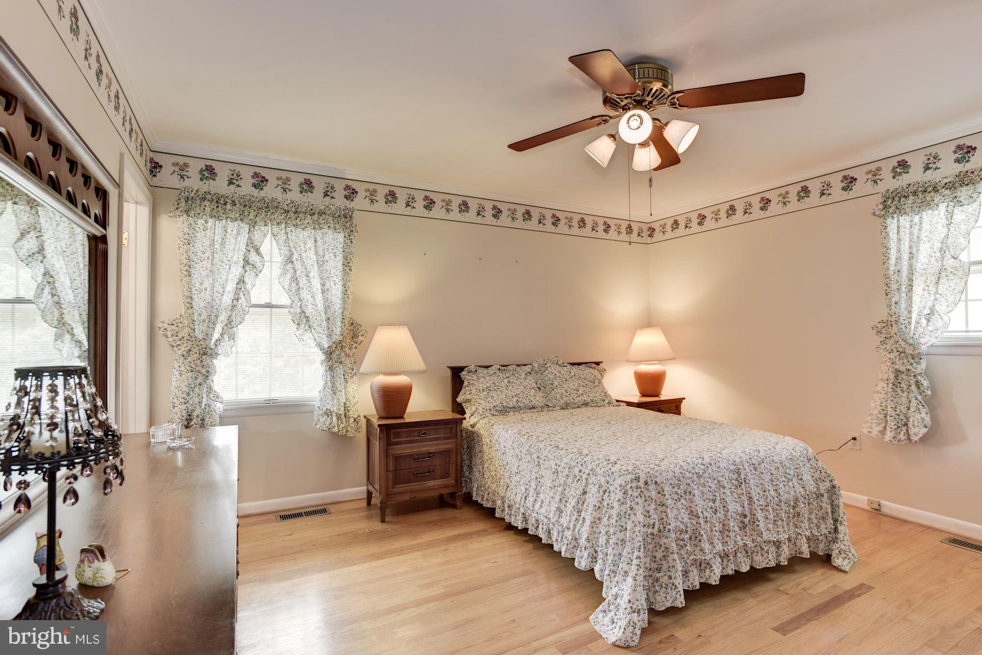 2514 Braddock Road Mount Airy, MD 21771 - Photo 10 of 30 a bedroom with a bed and a chandelier