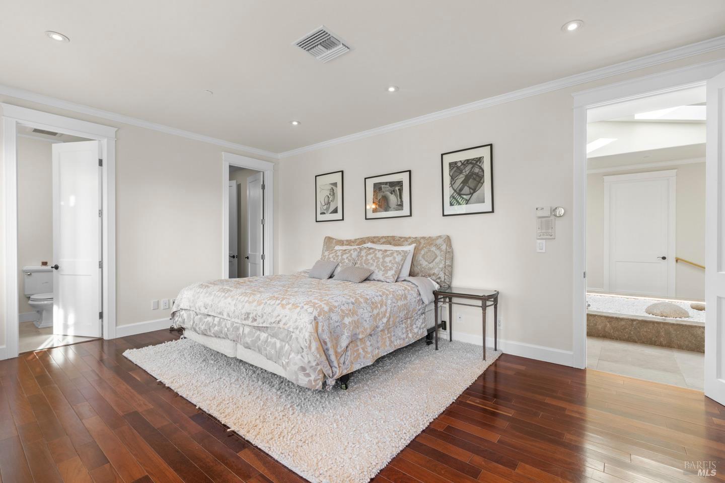 3001 Sears Point Road Sonoma, CA 95476 - Photo 31 of 52 a spacious bedroom with a bed and wooden floor