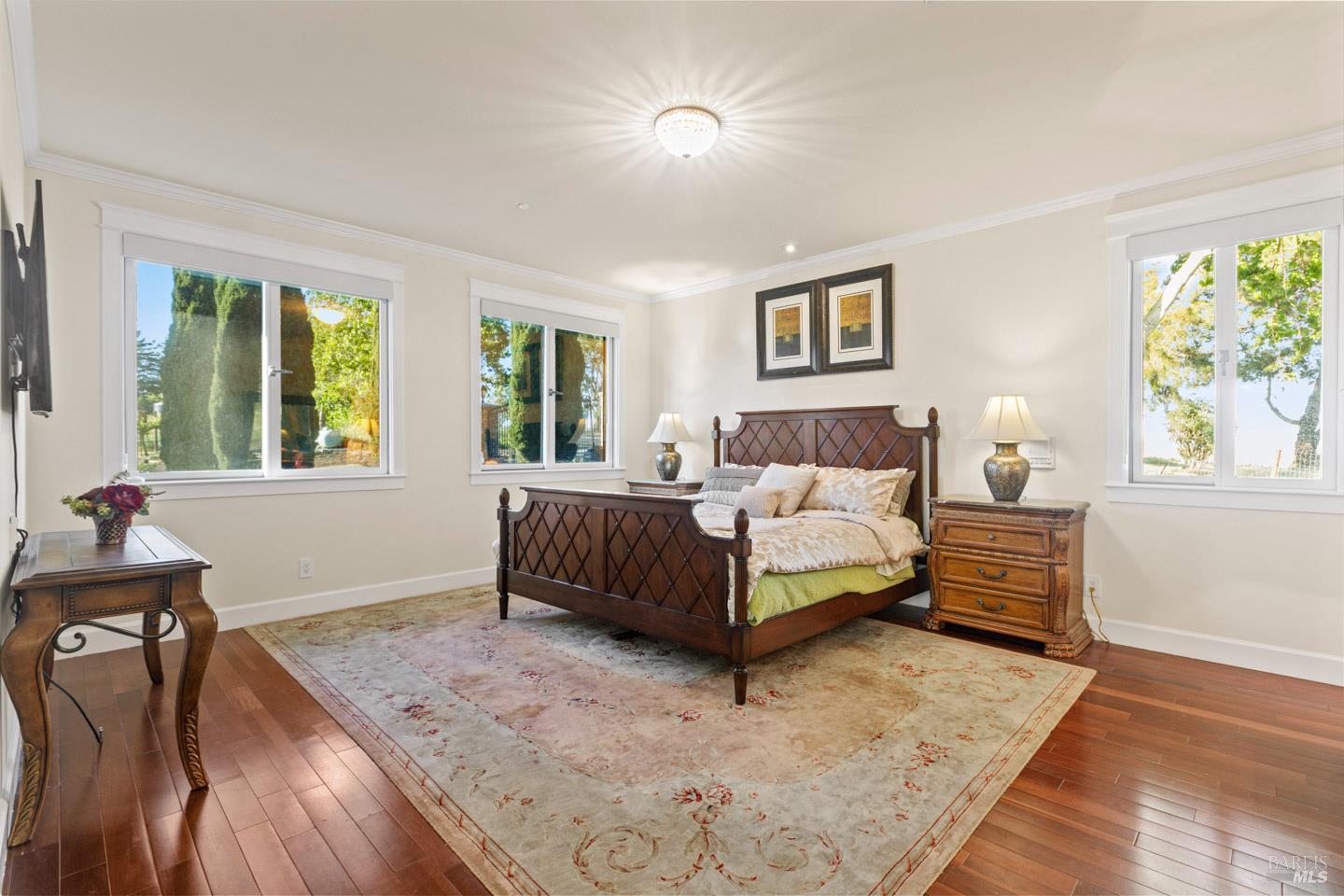 3001 Sears Point Road Sonoma, CA 95476 - Photo 33 of 52 a bedroom with a bed and wooden floor
