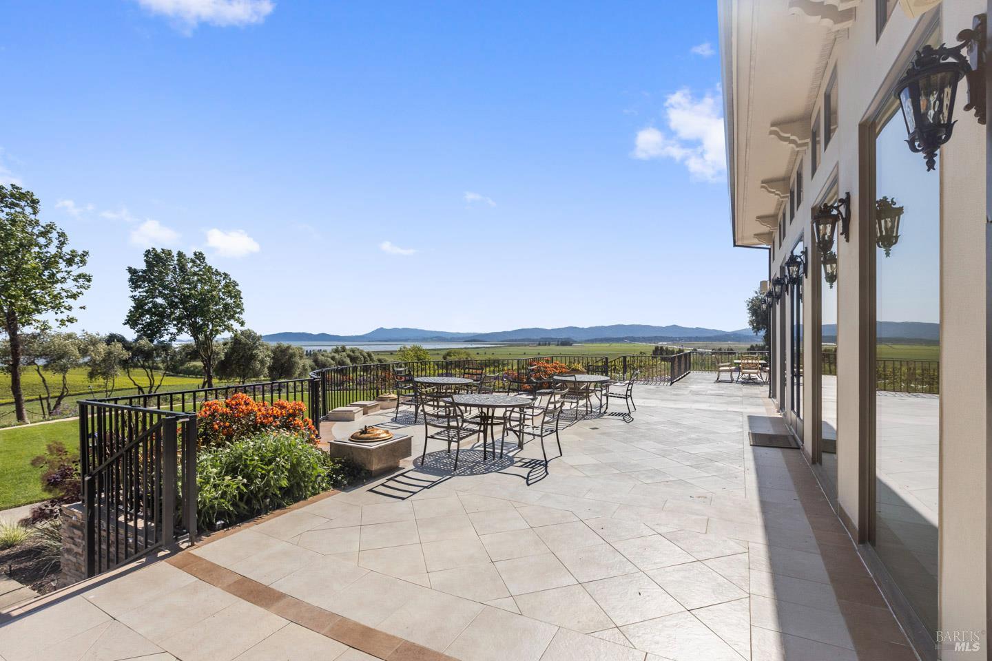 3001 Sears Point Road Sonoma, CA 95476 - Photo 46 of 52 a view of a patio with dining table and chairs with wooden floor and fence