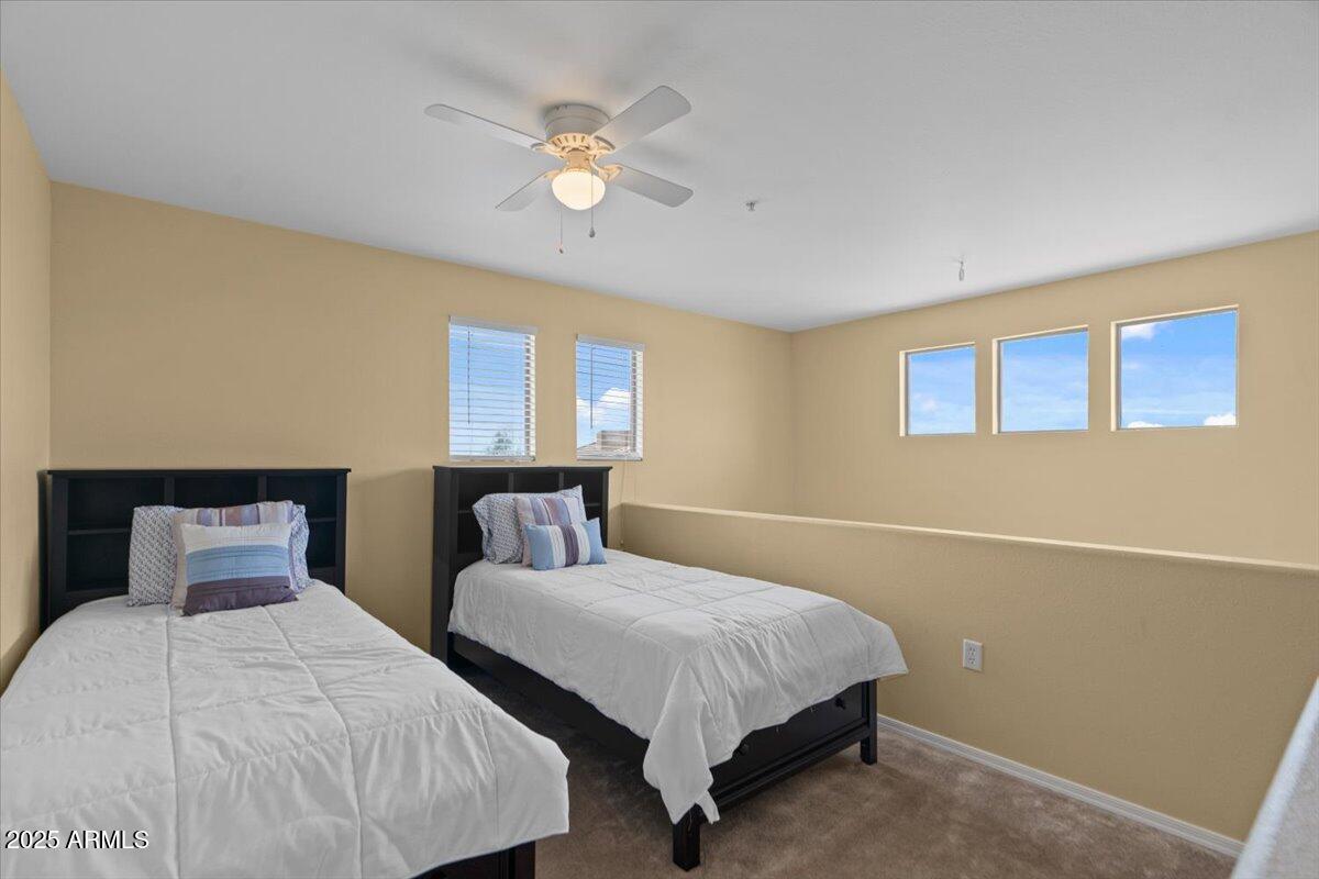 20100 North 78th Place, Unit 2203 Scottsdale, AZ 85255 - Photo 19 of 35 a bedroom with two beds and lamp