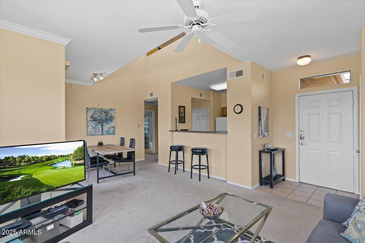 20100 North 78th Place, Unit 2203 Scottsdale, AZ 85255 - Photo 4 of 35 a living room with furniture and a flat screen tv