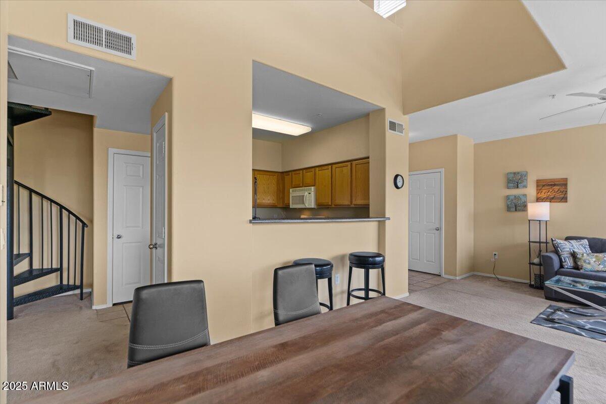 20100 North 78th Place, Unit 2203 Scottsdale, AZ 85255 - Photo 9 of 35 a living room with furniture and flat screen tv