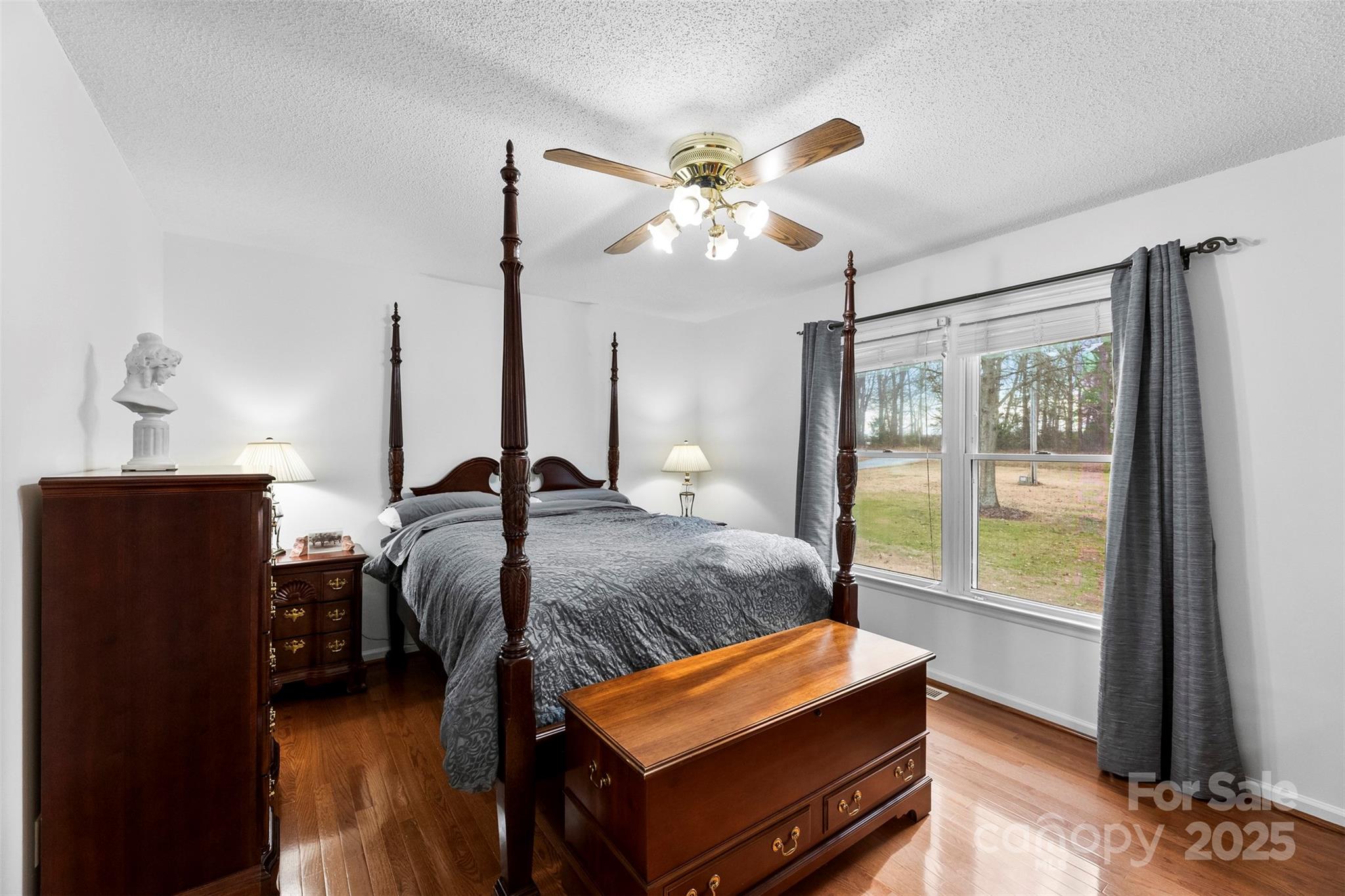 715 Deese Road Monroe, NC 28110 - Photo 12 of 28 a bedroom with a bed and wooden floor