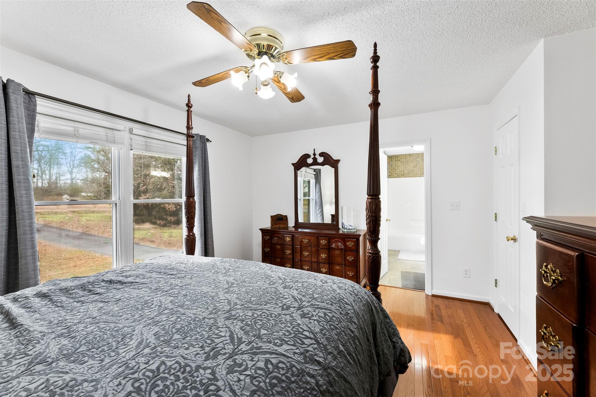 715 Deese Road Monroe, NC 28110 - Photo 14 of 28 a bedroom with a large bed and a chandelier