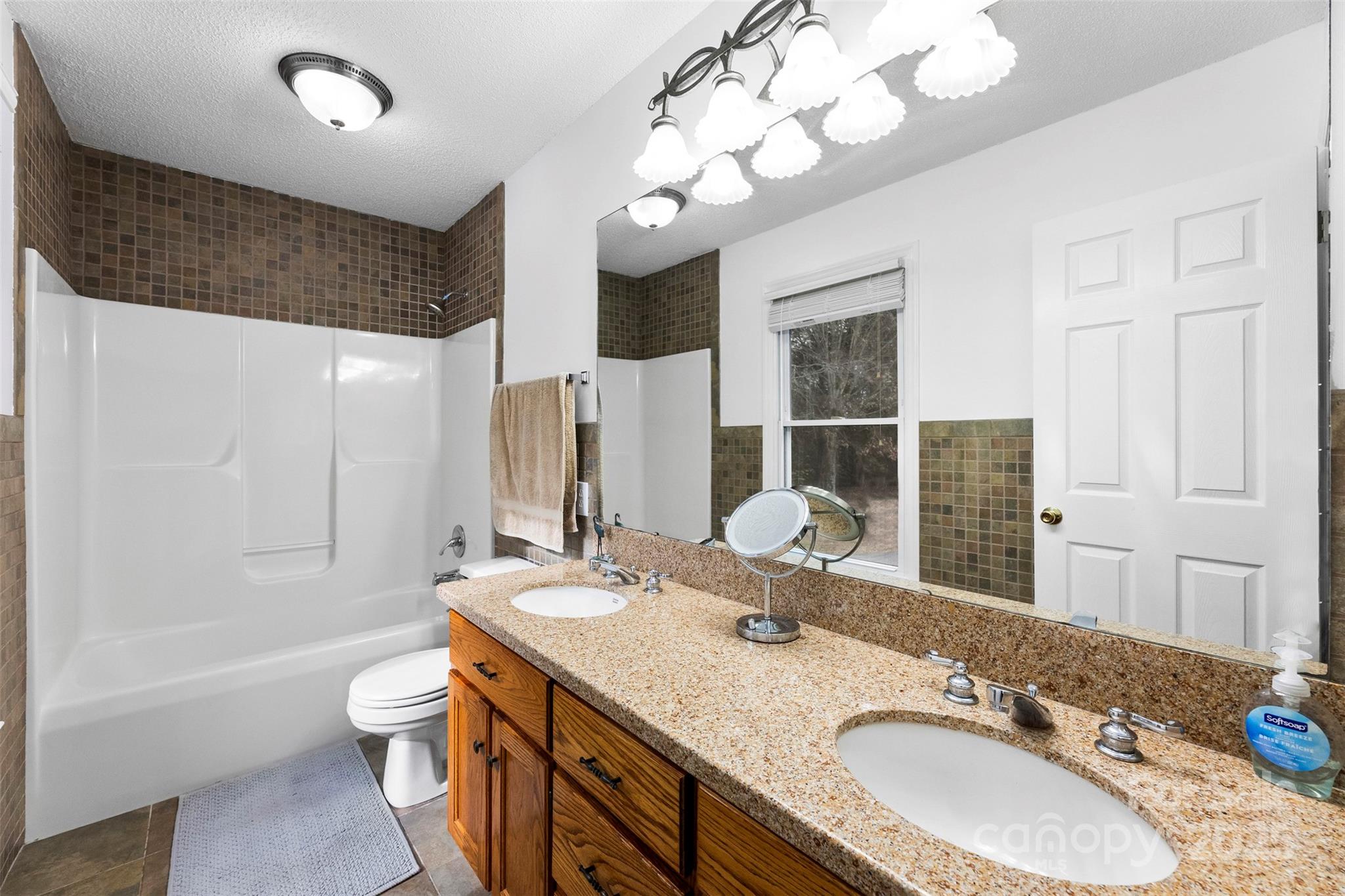 715 Deese Road Monroe, NC 28110 - Photo 15 of 28 a bathroom with a granite countertop double vanity sink mirror and bathtub