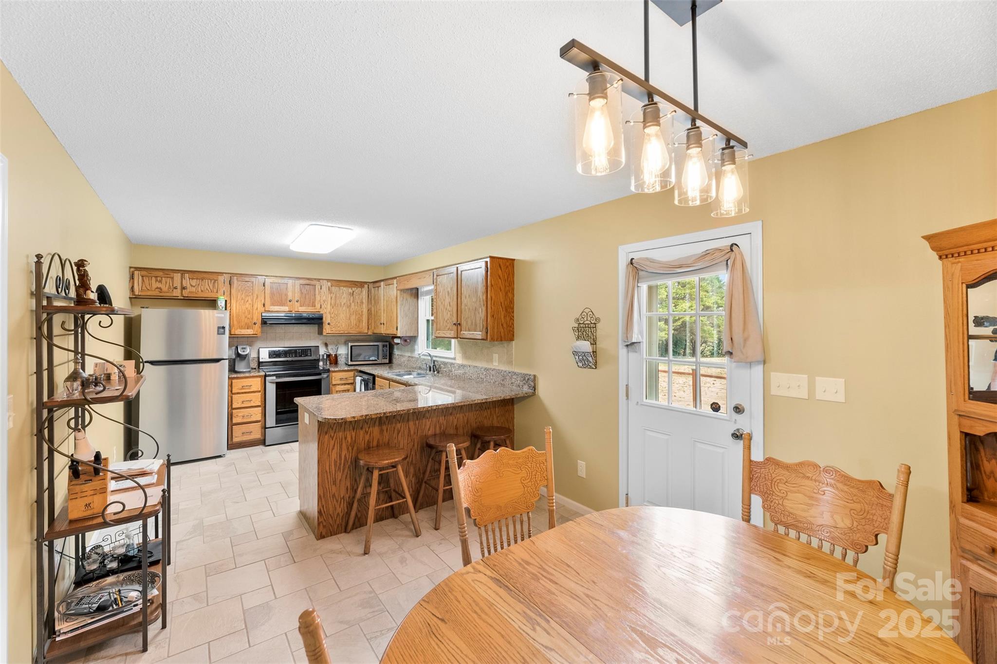 715 Deese Road Monroe, NC 28110 - Photo 9 of 28 a bedroom with furniture and a kitchen view