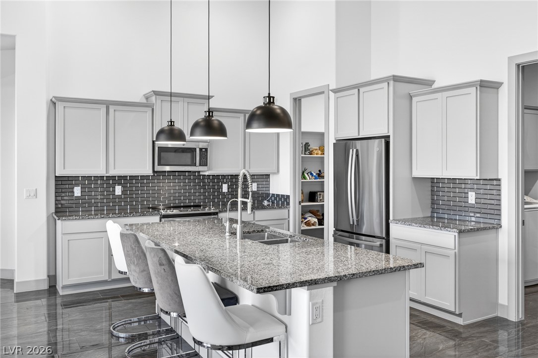 1460 Blue Ridge Trail Mesquite, NV 89027 - Photo 8 of 39 A well-appointed kitchen boasts sleek countertops, modern cabinetry, and stainless steel appliances.