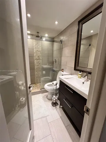 a bathroom with a double vanity sink toilet and shower