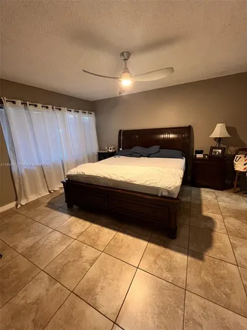 a bedroom with a bed and a shower