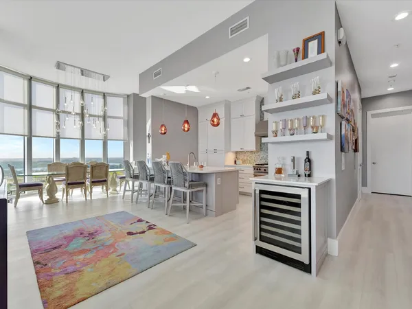 a living room with furniture a rug and a table