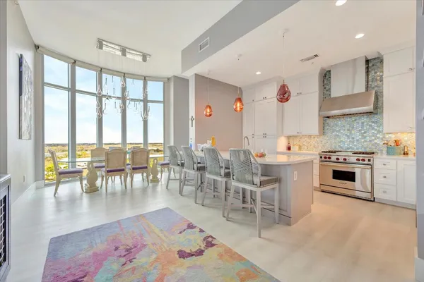 a large kitchen with a table and chairs