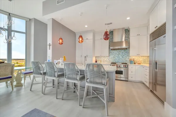 a kitchen with kitchen island a sink and a stove top oven