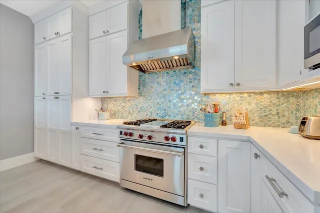 a kitchen with stainless steel appliances granite countertop a sink and a refrigerator