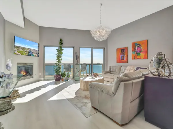 a living room with furniture and a chandelier