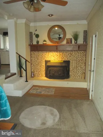 a hall with a fireplace and a mirror