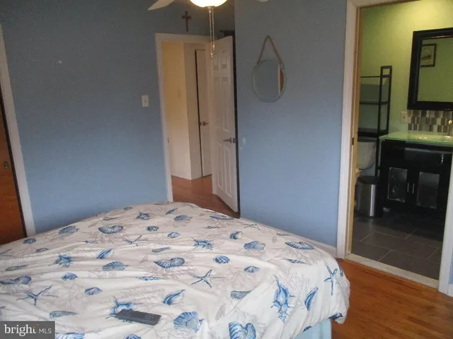 a bedroom with a bed and a mirror